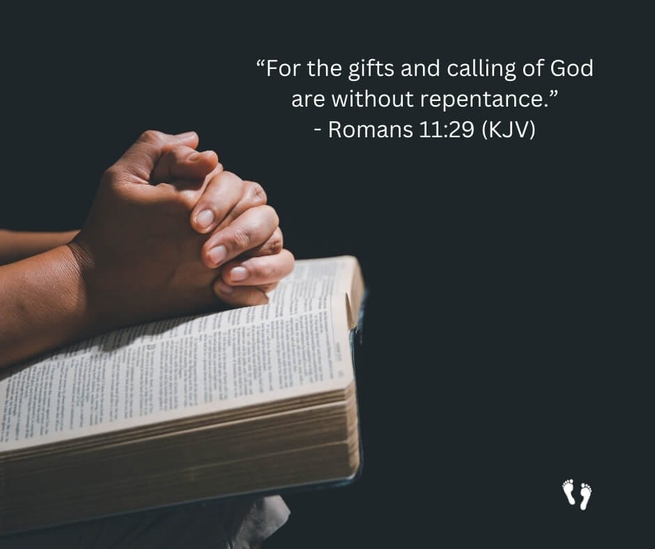 a person's hands folded over a bible